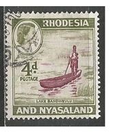 Родезия и Ньясаленд. Королева Елизавета II. Туземец на лодке. 1959г. Mi#24.