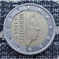 Люксембург 2 евро 2002 года. Король. Клеймо Гастауер-Клер Иветта. Лук со стрелой и звёздочкой и Посох Меркурия.